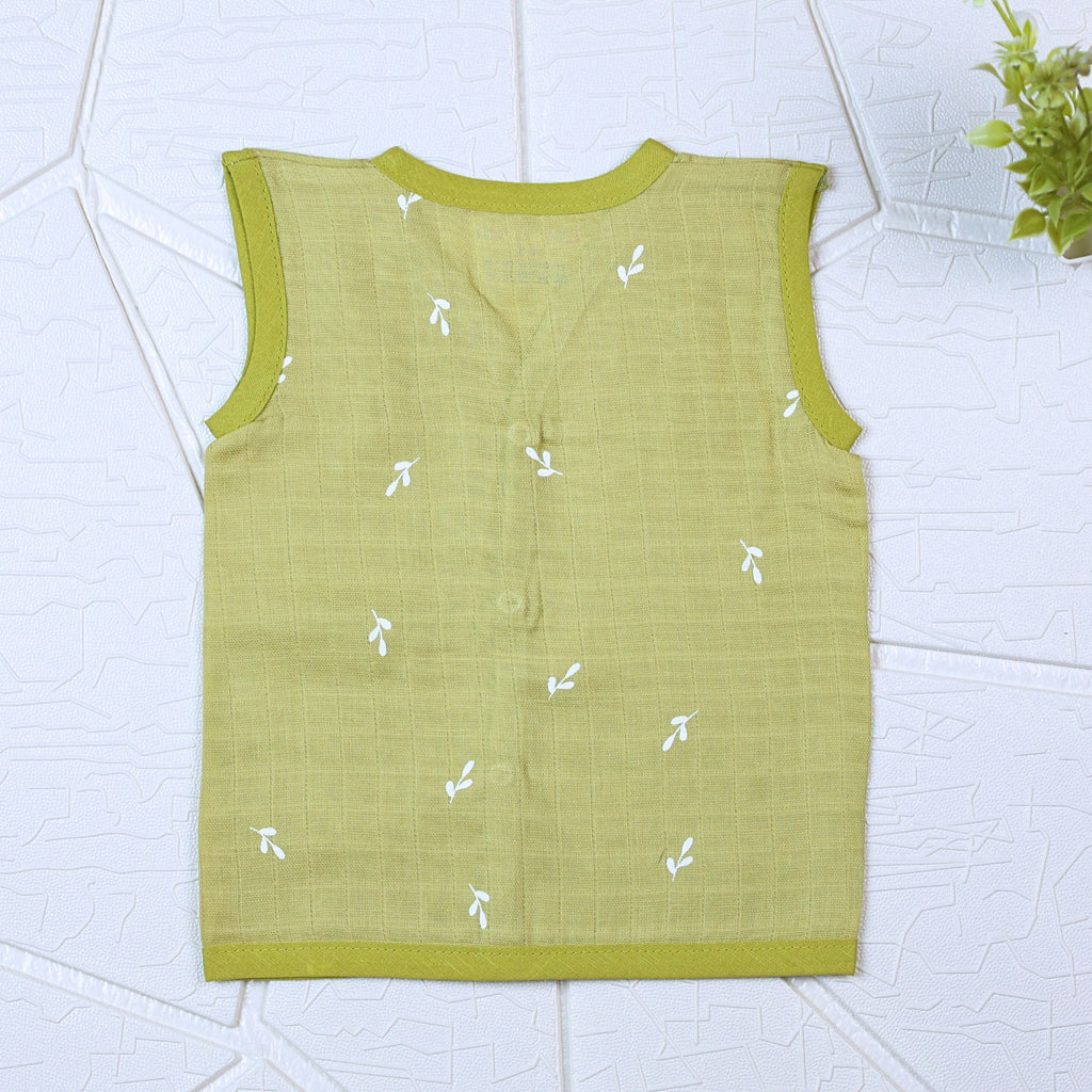 Green Twigs baby sleeveless top in green with snap buttons printed with white floral patterns