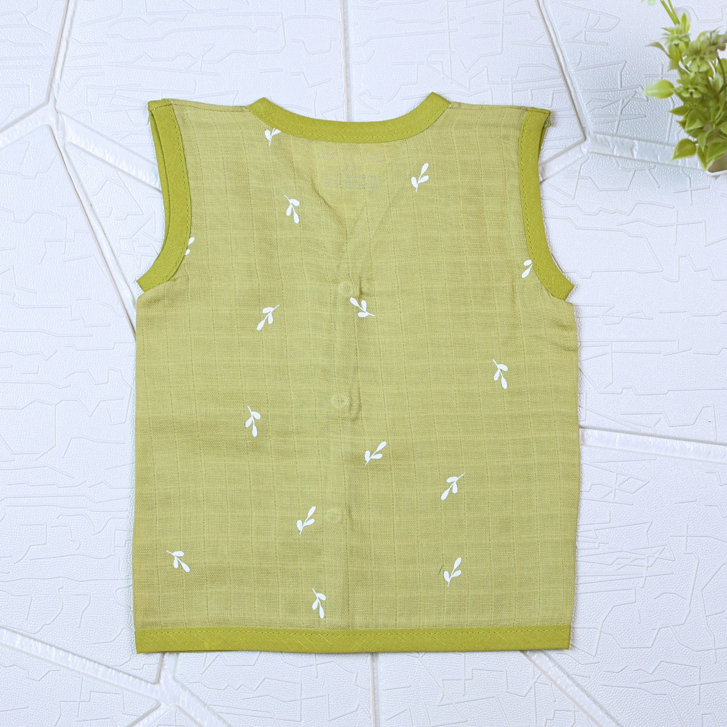 Green Twigs baby sleeveless top in green with snap buttons printed with white floral patterns