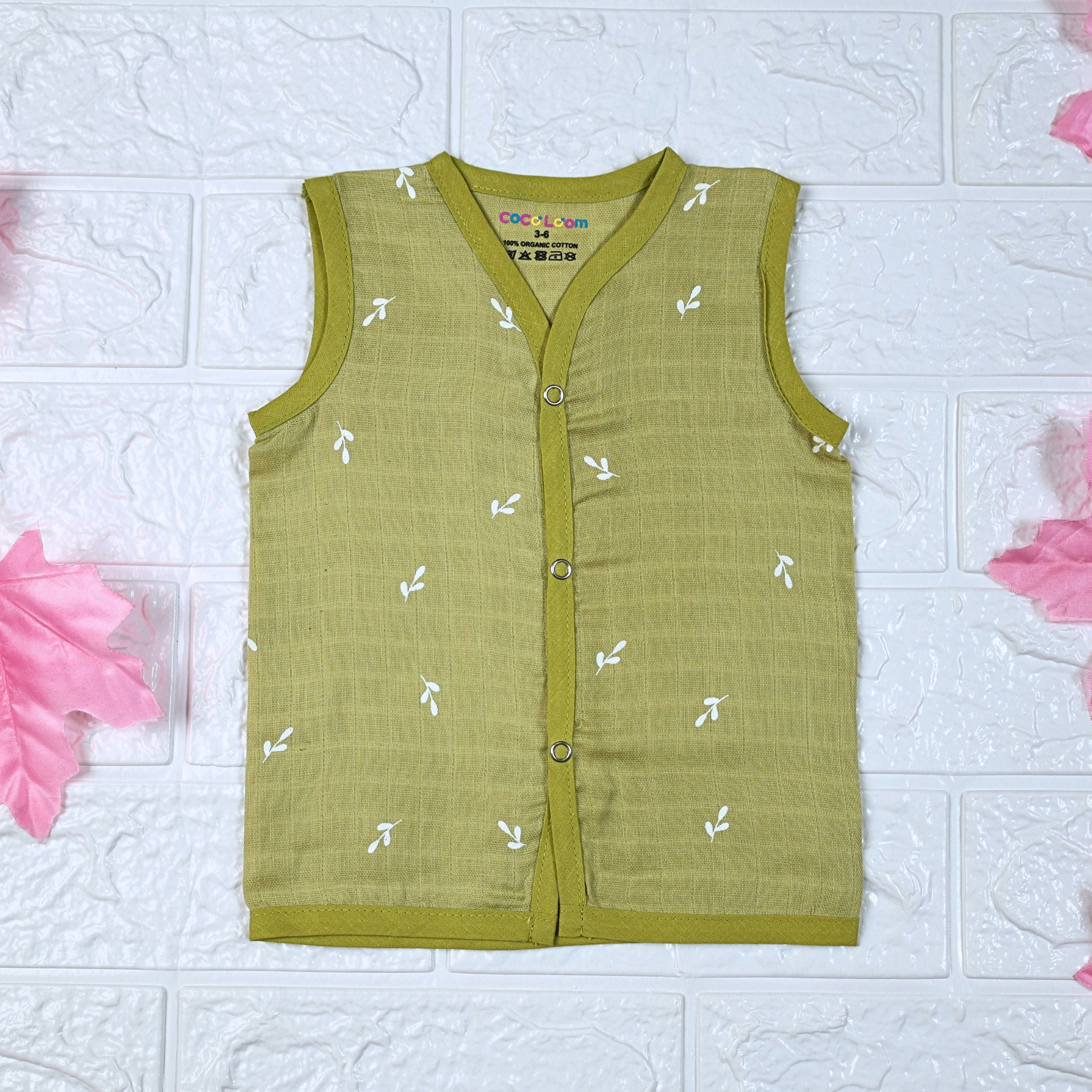 Green Twigs baby sleeveless top in green with snap buttons printed with white floral patterns