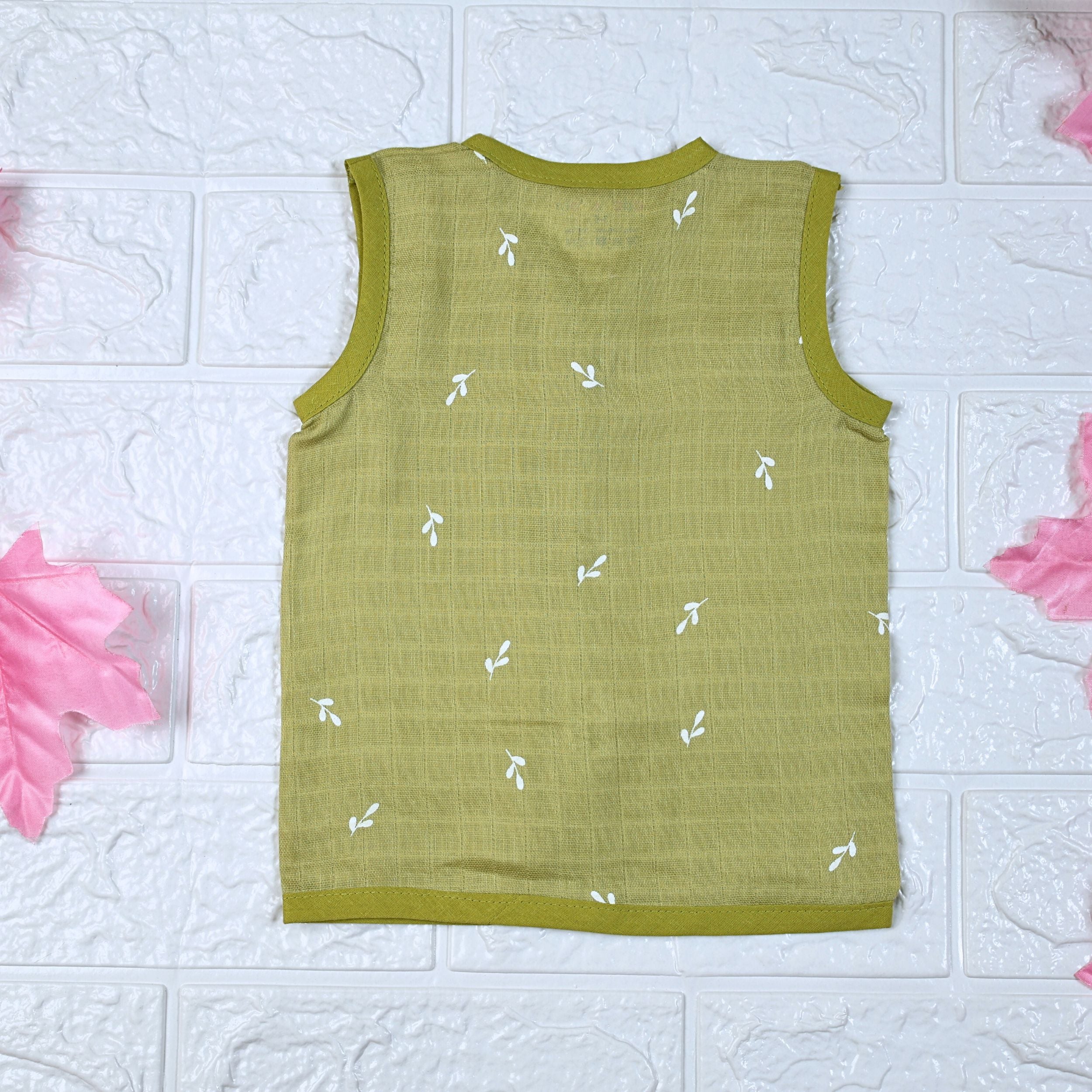 Green Twigs baby sleeveless top in green with snap buttons printed with white floral patterns