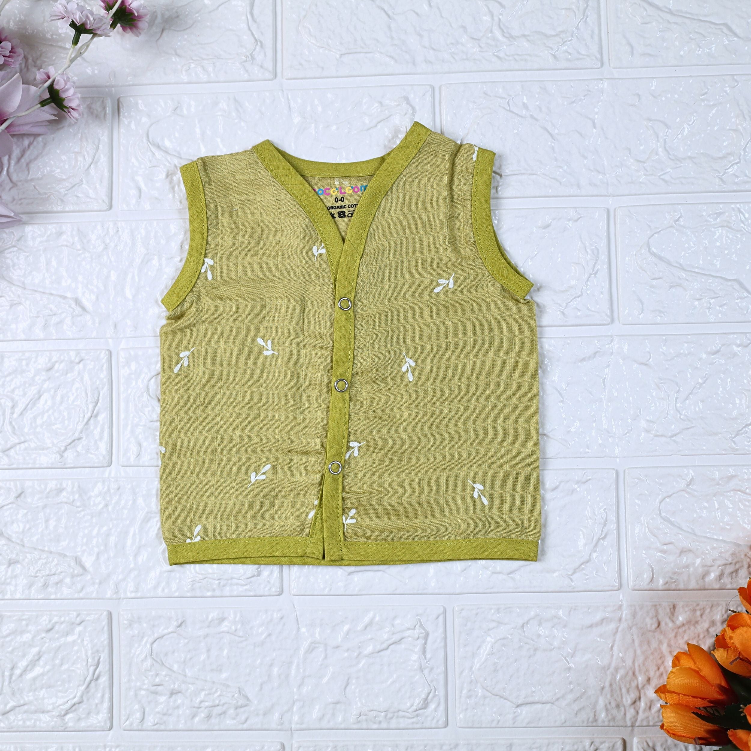 Green Twigs baby sleeveless top in green with snap buttons printed with white floral patterns