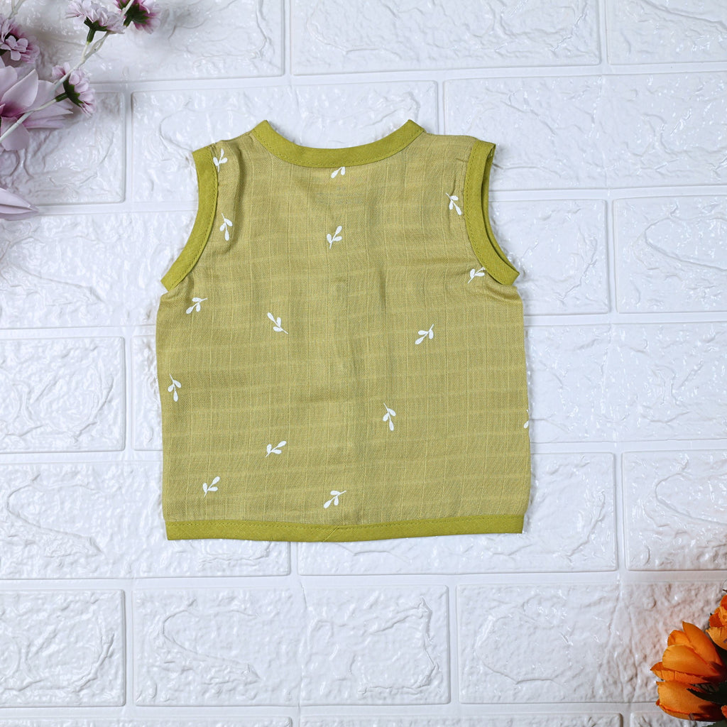 Green Twigs baby sleeveless top in green with snap buttons printed with white floral patterns