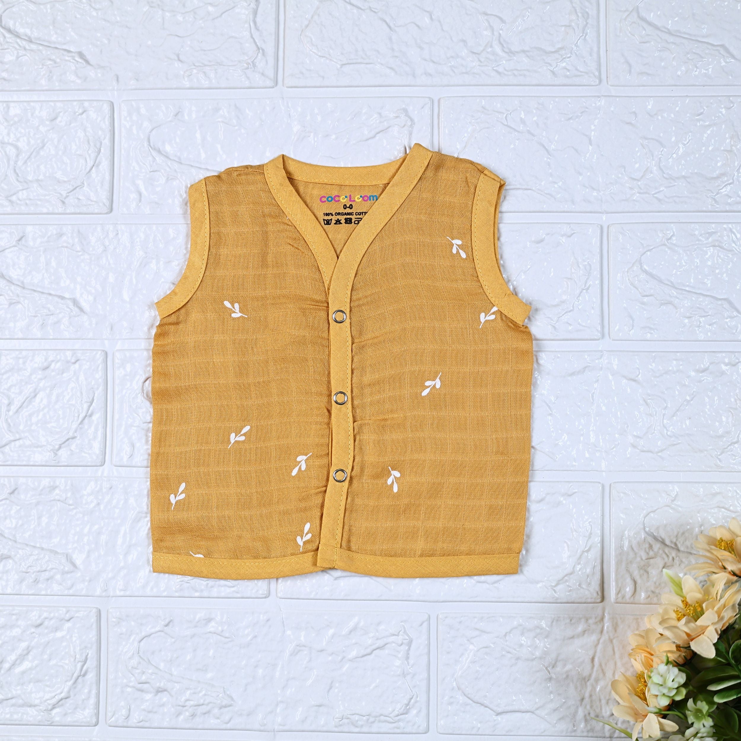 Mustard Sprigs baby sleeveless top in yellow with snap buttons printed with white floral patterns 