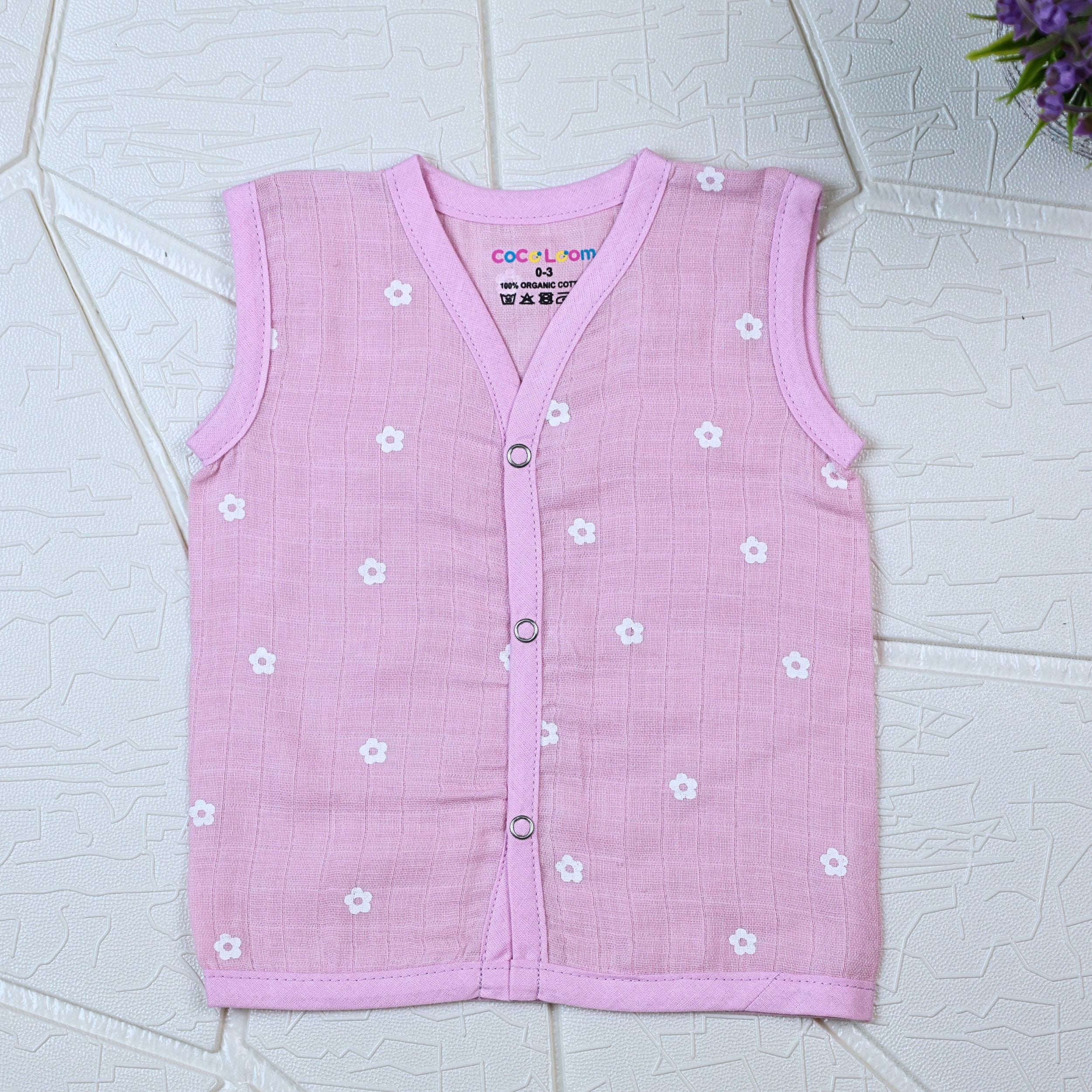 Pink Daisy baby sleeveless top in pink with snap buttons printed with white floral patterns