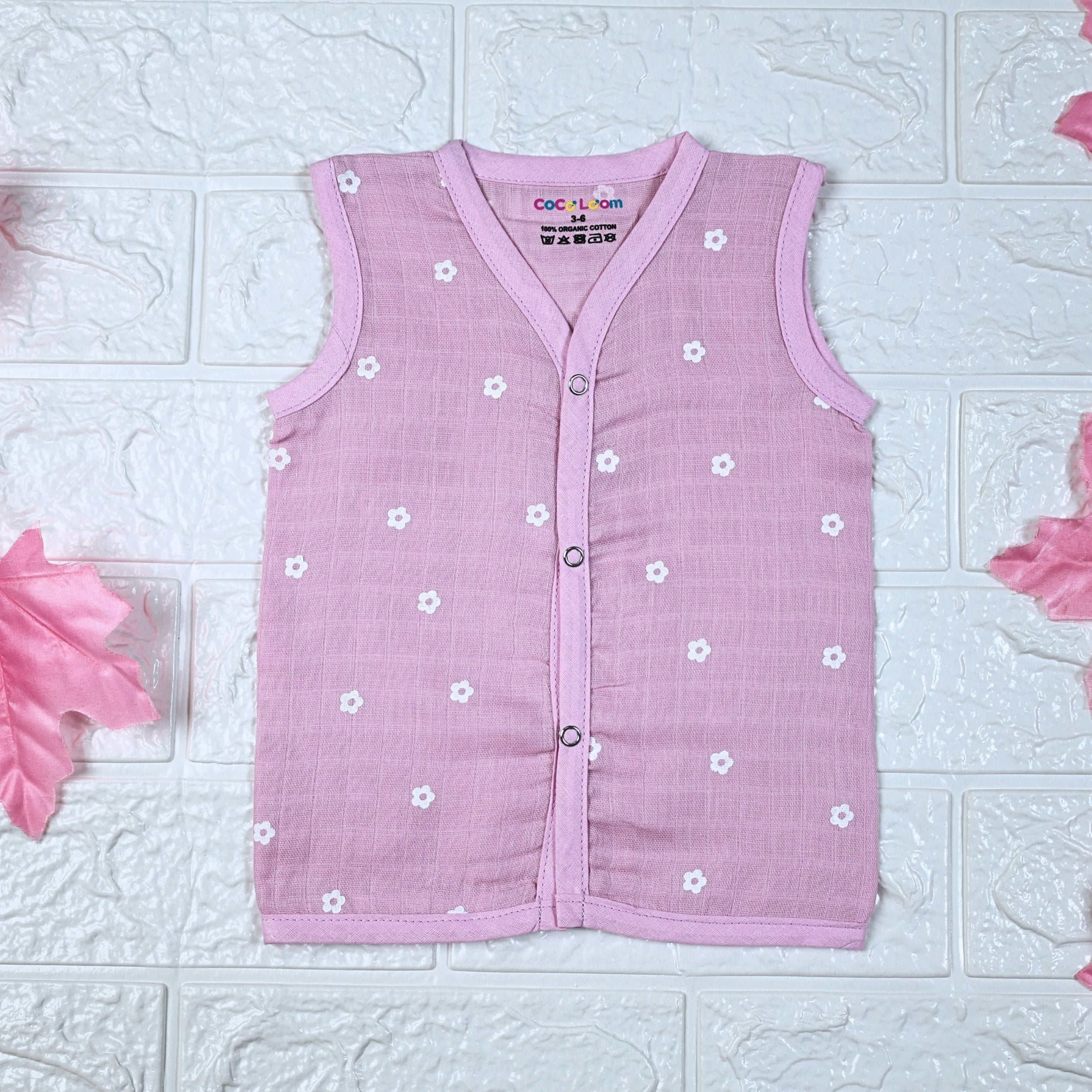 Pink Daisy baby top in pink with snap buttons printed with white floral patterns