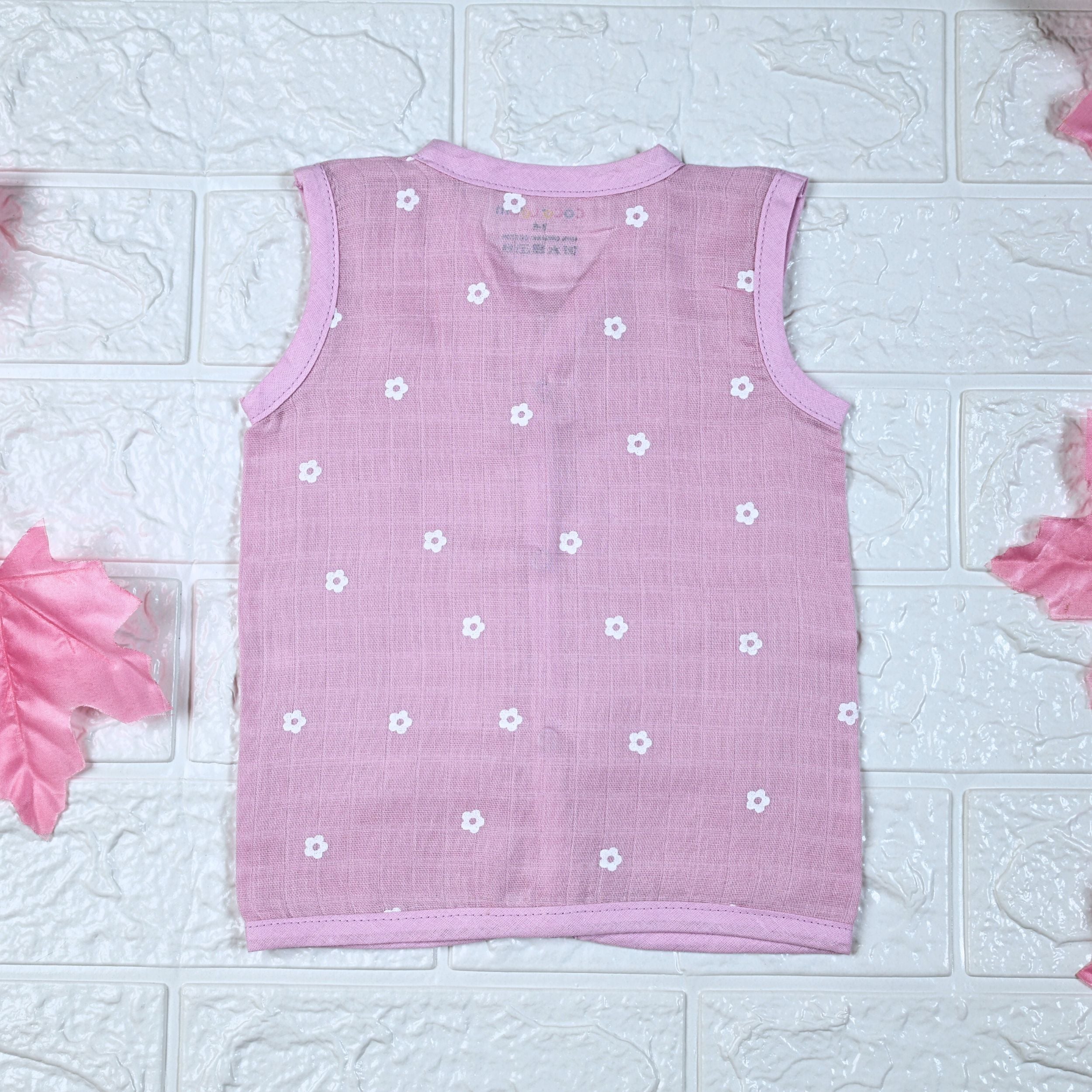 Pink Daisy baby top in pink with snap buttons printed with white floral patterns