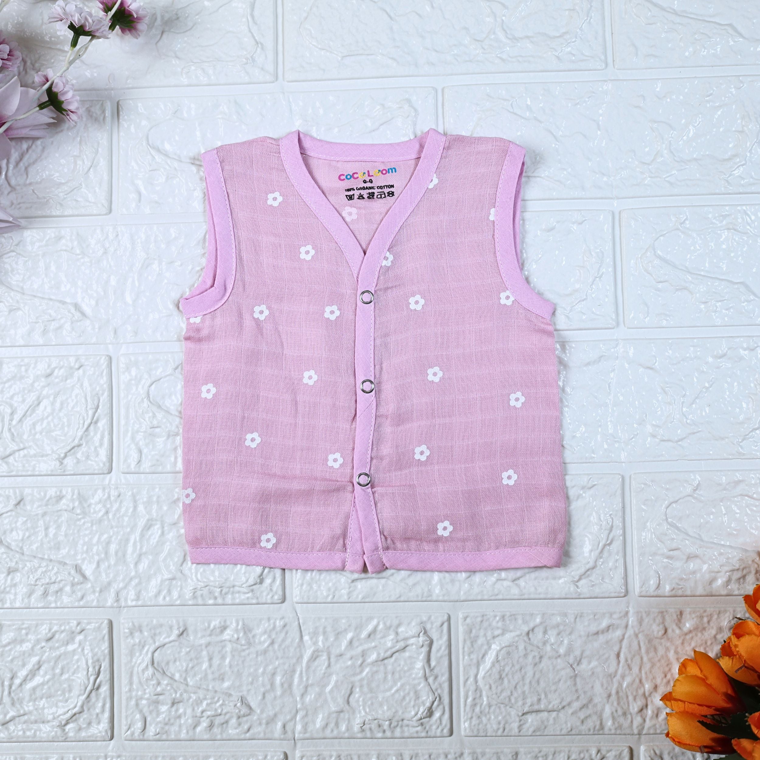 Pink Daisy baby sleeveless top in pink with snap buttons printed with white floral patterns