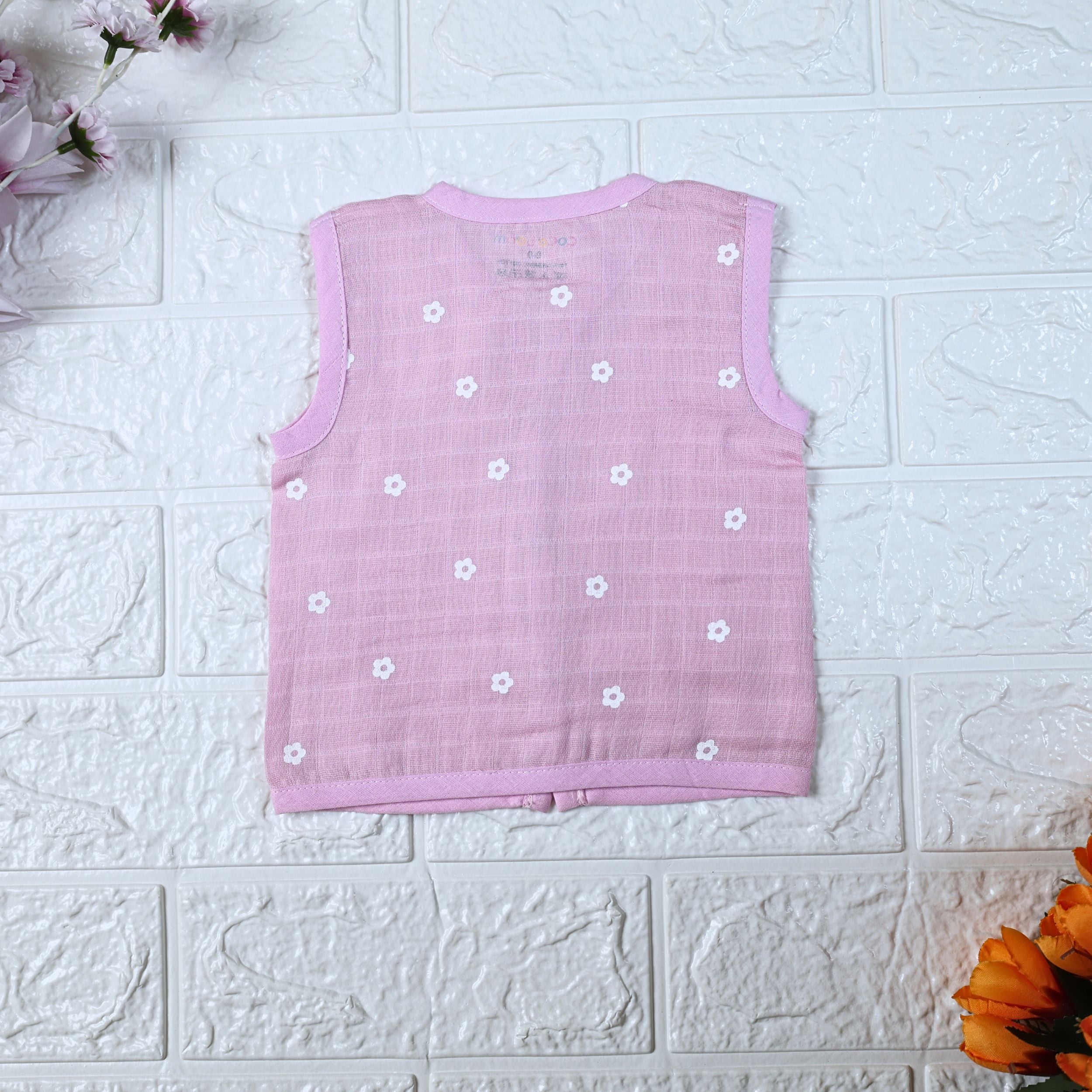 Pink Daisy baby sleeveless top in pink with snap buttons printed with white floral patterns