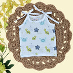 Aqua Babies baby top in white with tie up shoulders printed with turtle and starfish pattern