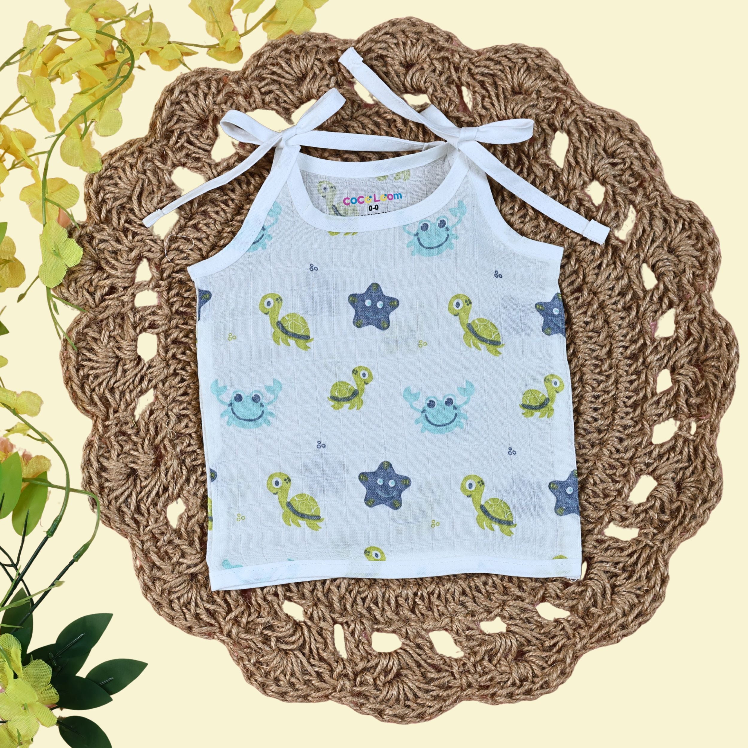 Aqua Babies baby top in white with tie up shoulders printed with turtle and starfish pattern