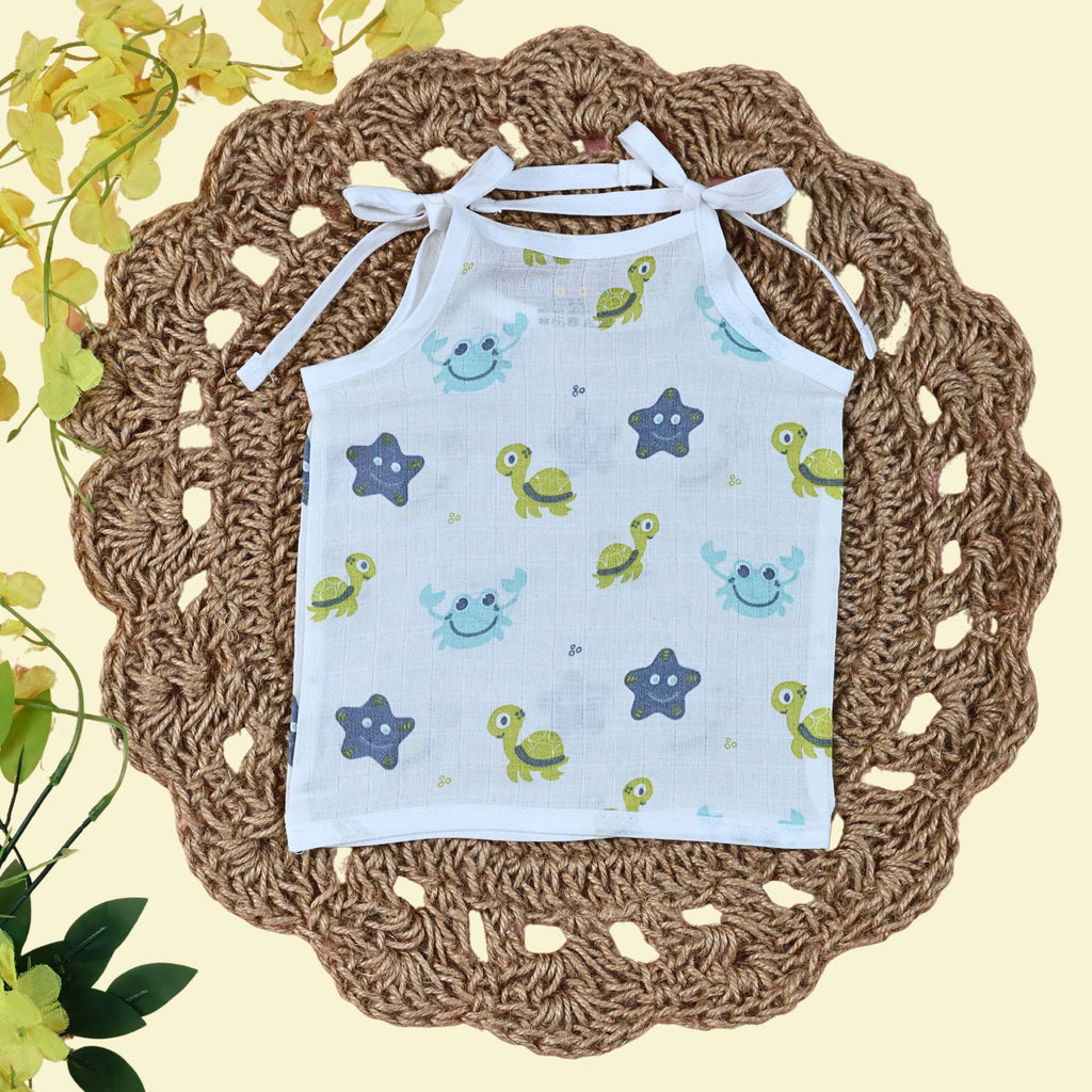Aqua Babies baby top in white with tie up shoulders printed with turtle and starfish pattern