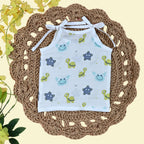 Aqua Babies baby top in white with tie up shoulders printed with turtle and starfish pattern
