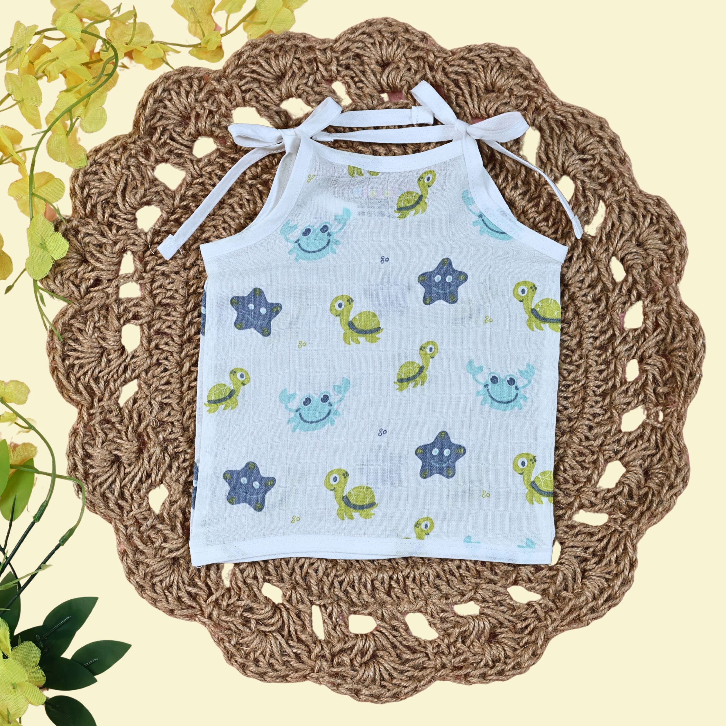 Aqua Babies baby top in white with tie up shoulders printed with turtle and starfish pattern