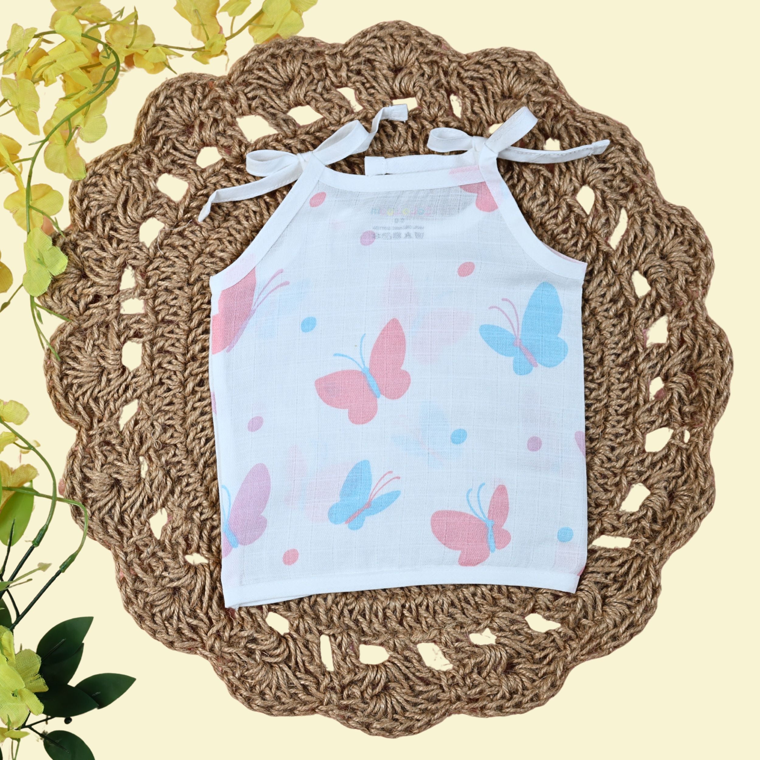 Butterfly Blush baby top in white tie up shoulders, printed with colourful butterfly pattern 
