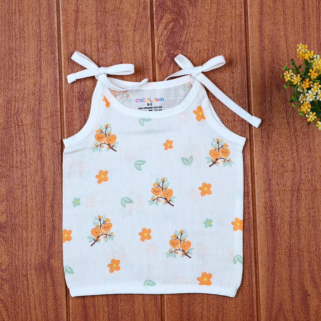Citrus Bloom top in white with shoulder knot, printed with orange floral patterns