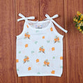 Citrus Bloom top in white with shoulder knot, printed with orange floral patterns
