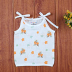 Citrus Bloom top in white with shoulder knot, printed with orange floral patterns