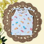 Feathers baby top in white with tie up shoulders, printed with colourful leaf patterns