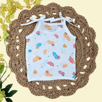 Feathers baby top in white with tie up shoulders, printed with colourful leaf patterns