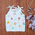 Little Veggies baby sleeveless top in white with tie up shoulders, printed with colorful veggie patterns