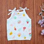 Little Veggies baby sleeveless top in white with tie up shoulders, printed with colorful veggie patterns
