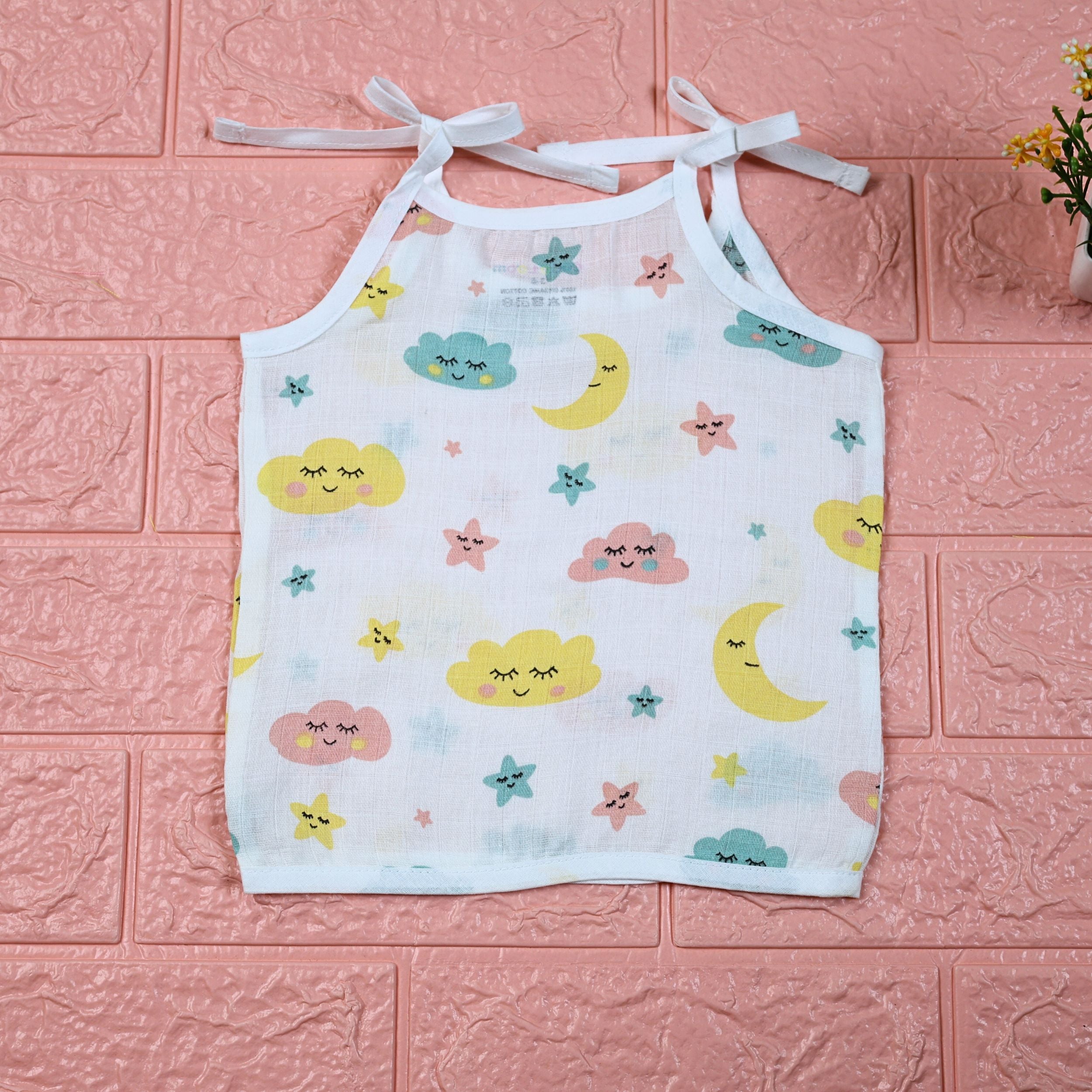 Twinkle Sky baby top in white with tie-up shoulders, printed with pastel cloud, stars and moon.
