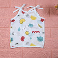 Wild Doodles baby top in white with shoulder knots, yellow, red and pastel green scribble patterns.