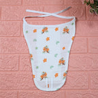 Citrus Bloom Baby nappy in white with tie up knot, printed with orange floral patterns