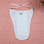 Citrus Bloom Baby nappy in white with tie up knot, printed with orange floral patterns