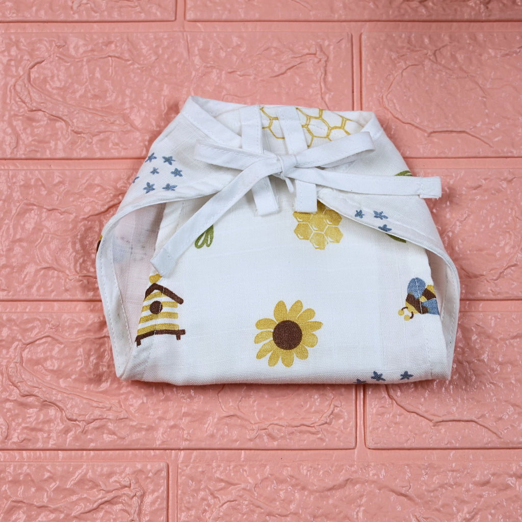 Honey Bloom Baby nappy in white with tie up knot printed with floral and bee pattern