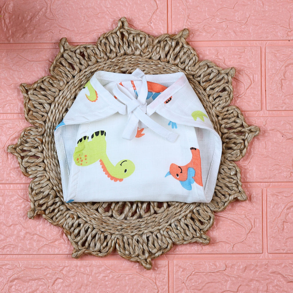 Little Dino Baby Nappy in white with tie up knot, printed with orange and green dinosaur design