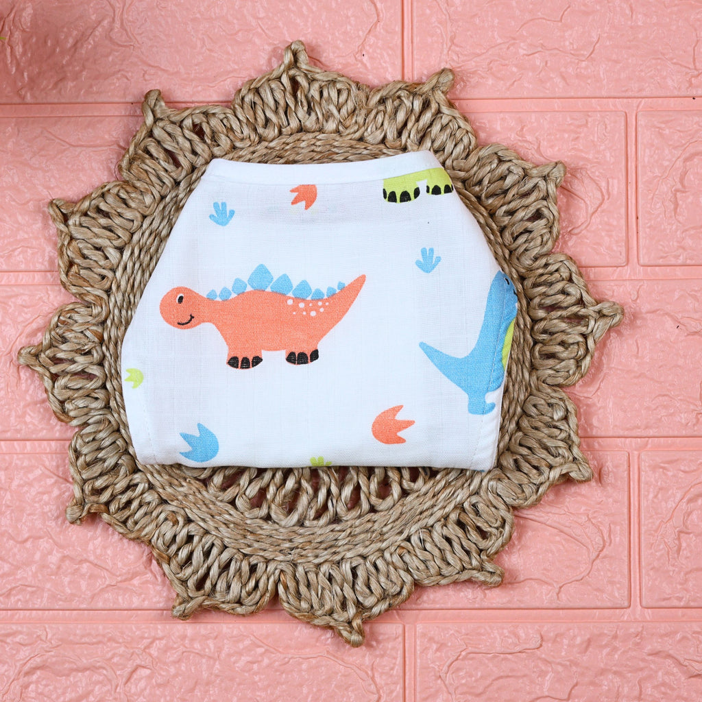 Little Dino Baby Nappy in white with tie up knot, printed with orange and green dinosaur design