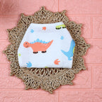Little Dino Baby Nappy in white with tie up knot, printed with orange and green dinosaur design