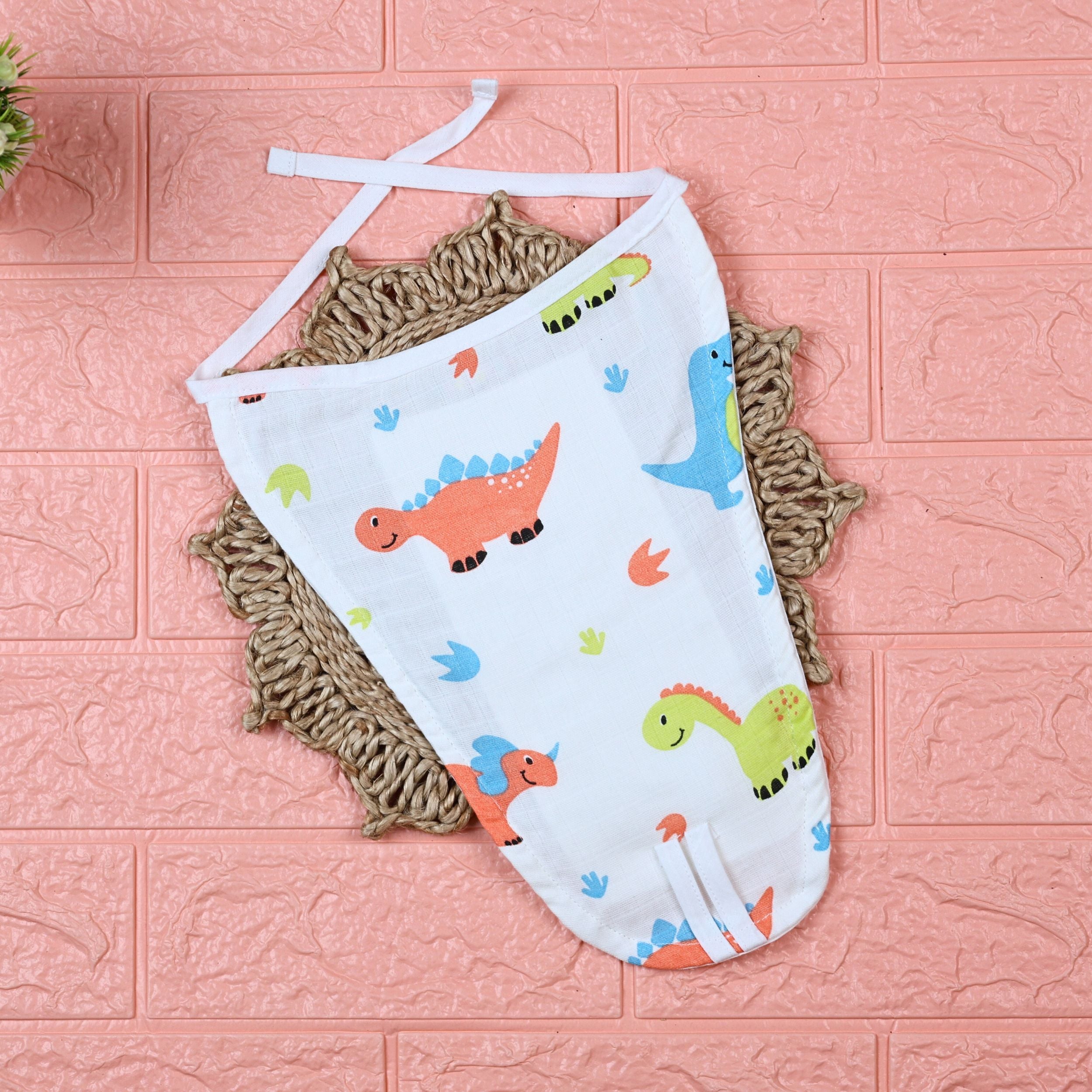 Little Dino Baby Nappy in white with tie up knot, printed with orange and green dinosaur design