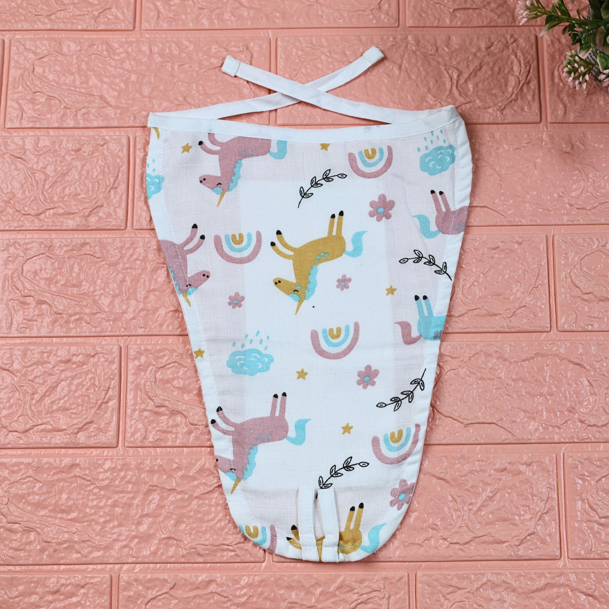 Unicorn baby nappy in white with knots, printed with colourful unicorn pattern