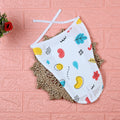 Wild Doodles Baby Nappy in white with tie up knots, printed with yellow, red and pastel green scribble patterns.