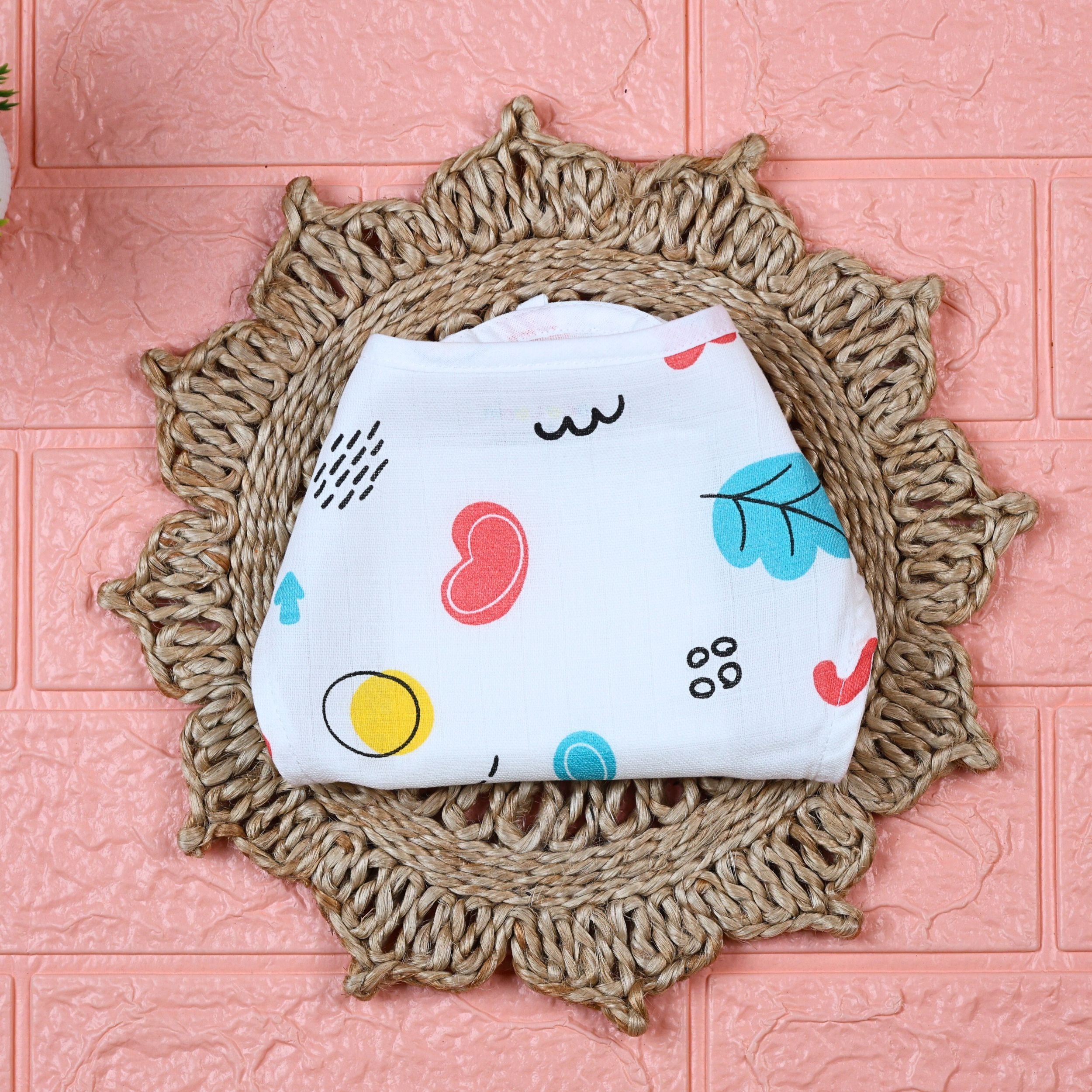 Wild Doodles Baby Nappy in white with tie up knots, printed with yellow, red and pastel green scribble patterns.