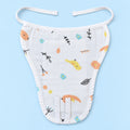A white muslin baby nappy/langot with a playful pattern of small yellow birds, orange birds, blue flowers, and black branch motifs, laid flat on a light blue background.