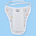 A white muslin baby bib with delicate pastel floral and bird patterns, featuring adjustable ties and a central patch set against a solid light blue background.