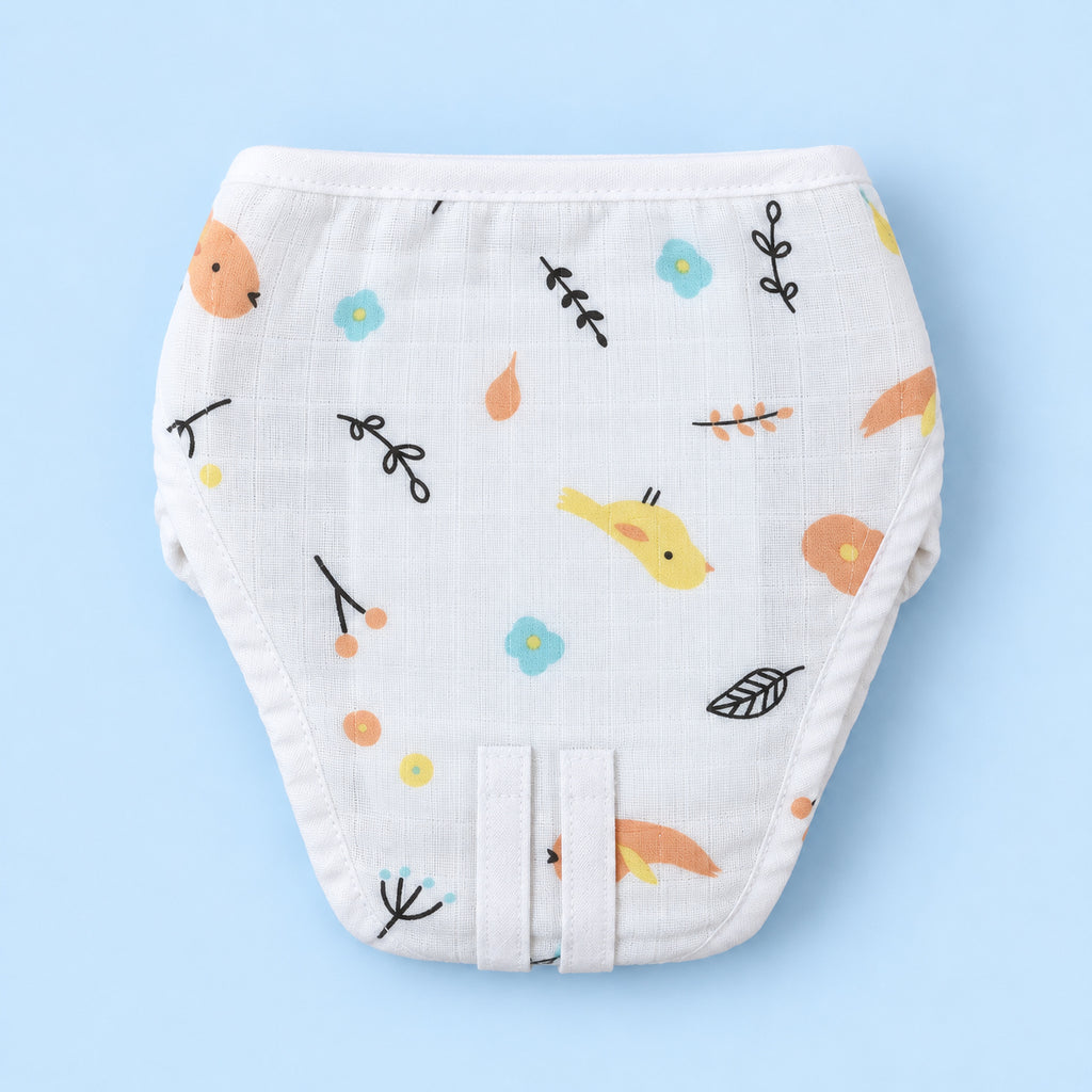 A white reusable cloth diaper with a colorful nature-themed print of birds, flowers, leaves, and orange foxes, displayed flat against a light blue background.