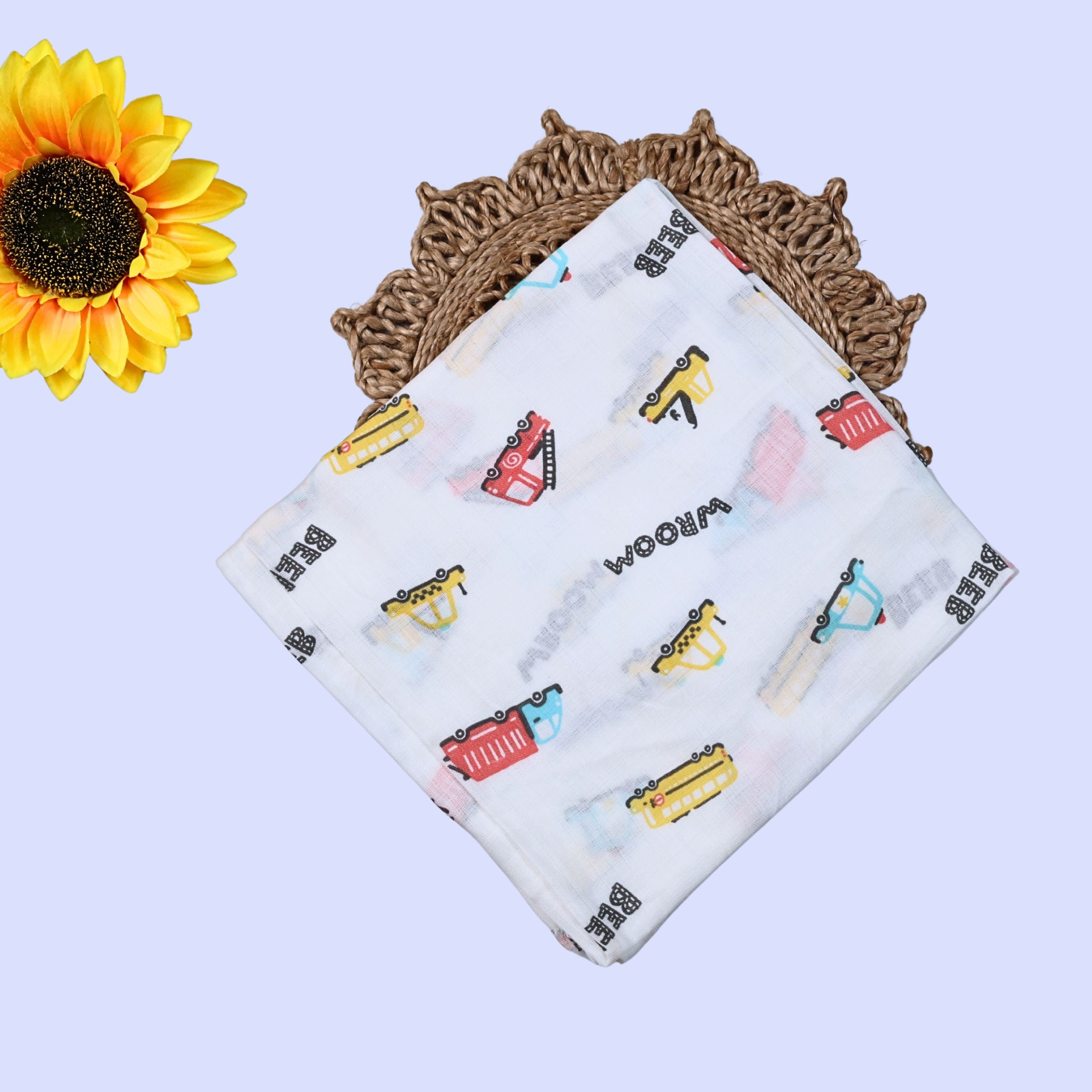 Beed Rides Baby Swaddle in white with tie up knots, printed with vehicle patterns