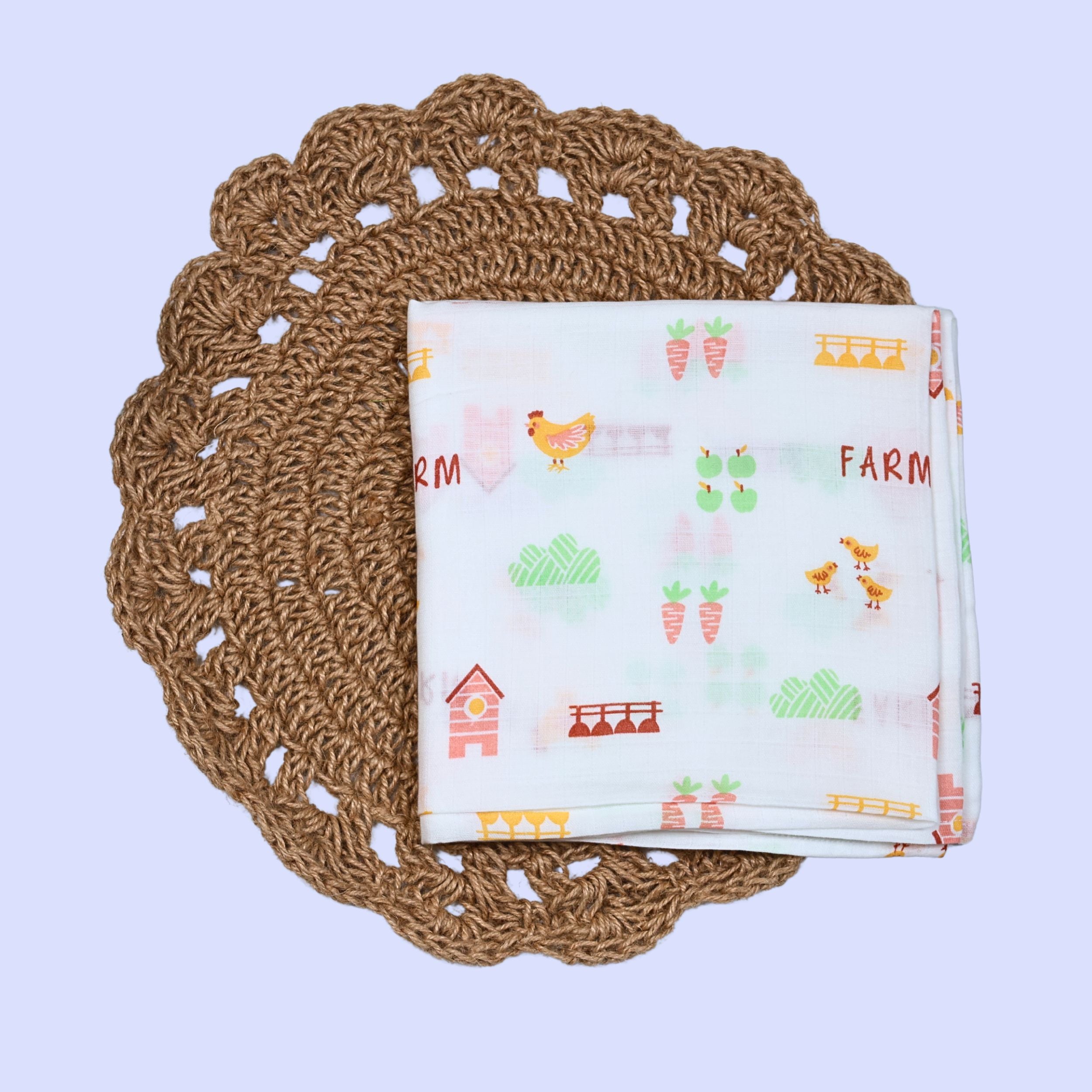 Farm Tales Baby Swaddle in white printed with farm-themed pattern