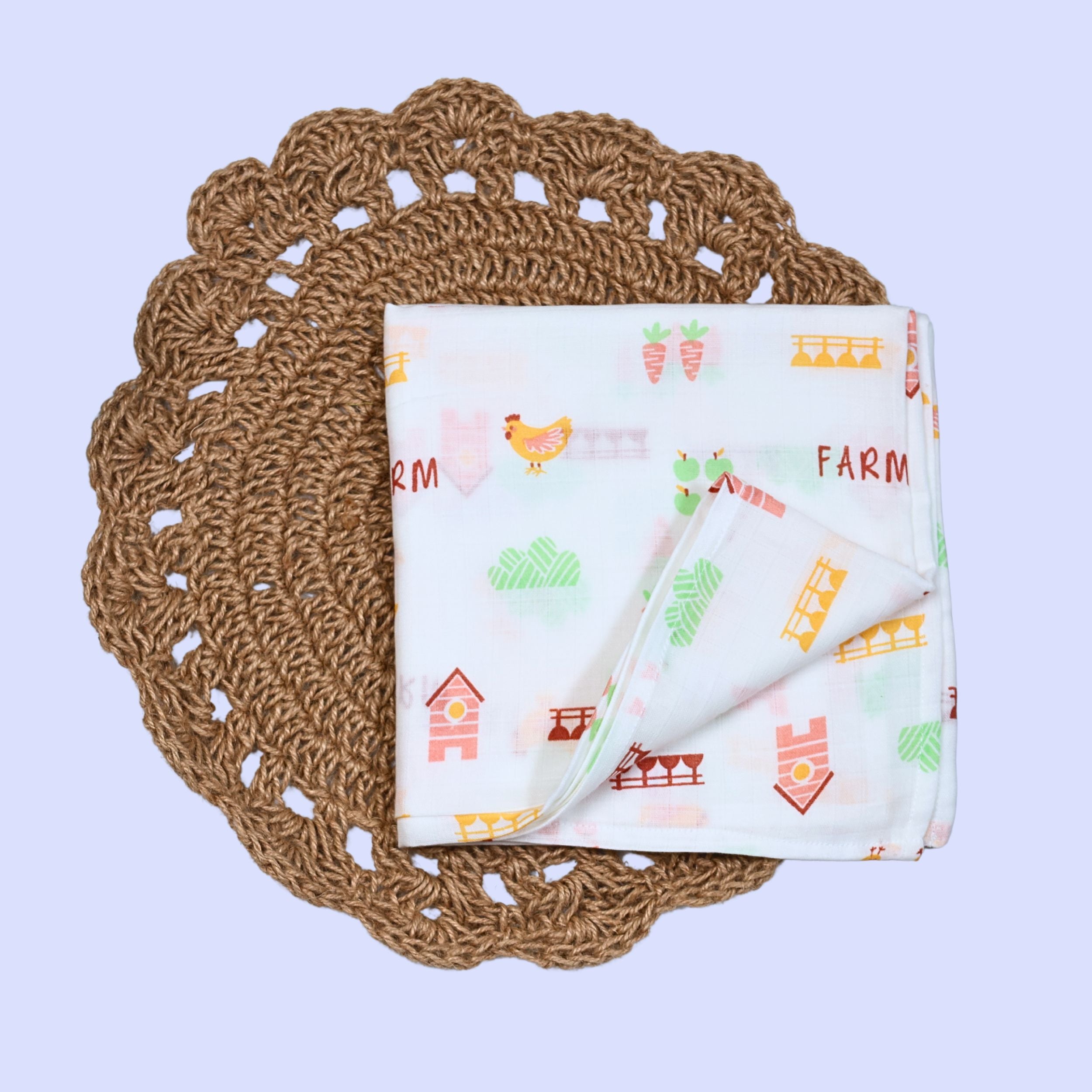 Farm Tales Baby Swaddle in white printed with farm-themed pattern