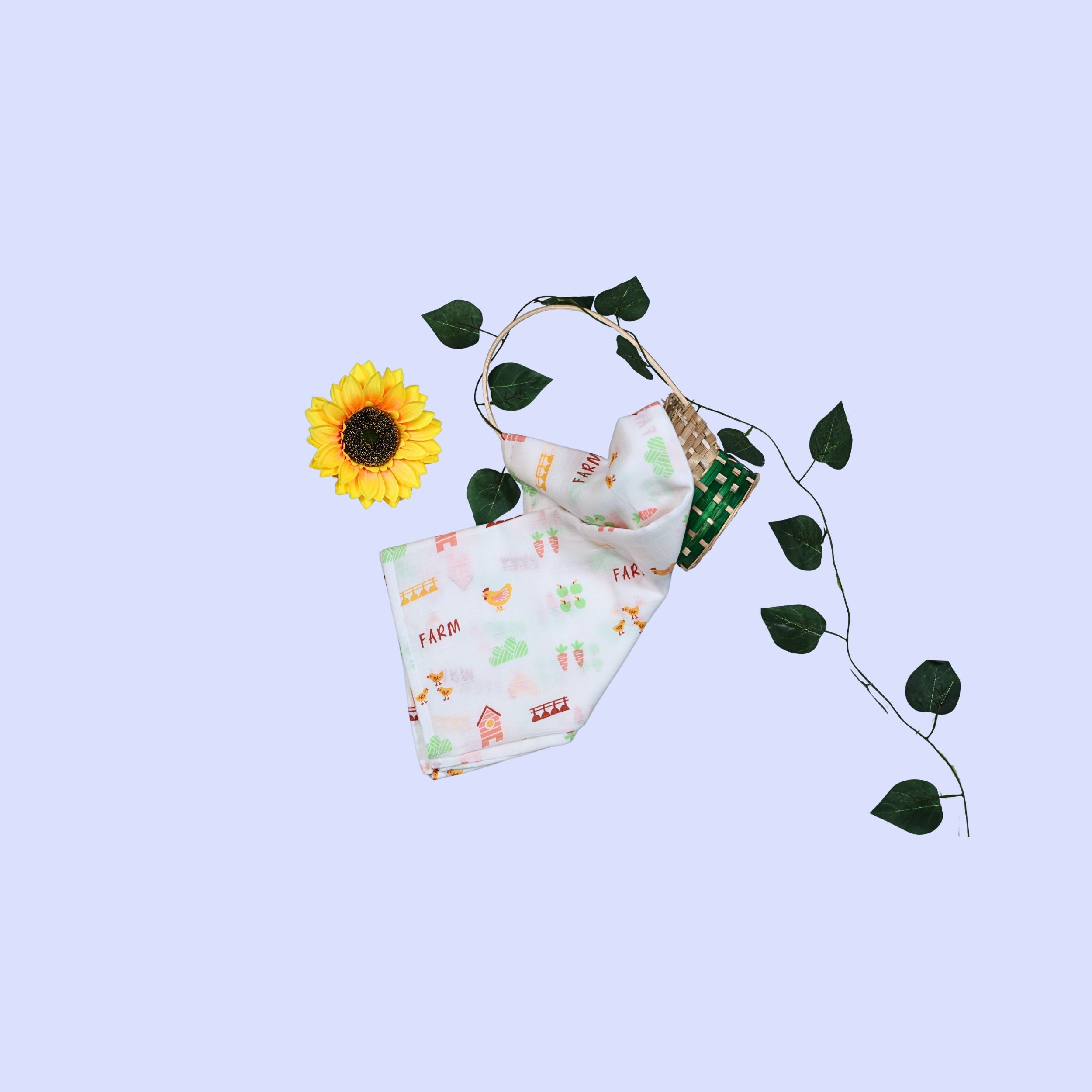Farm Tales Baby Swaddle in white printed with farm-themed pattern