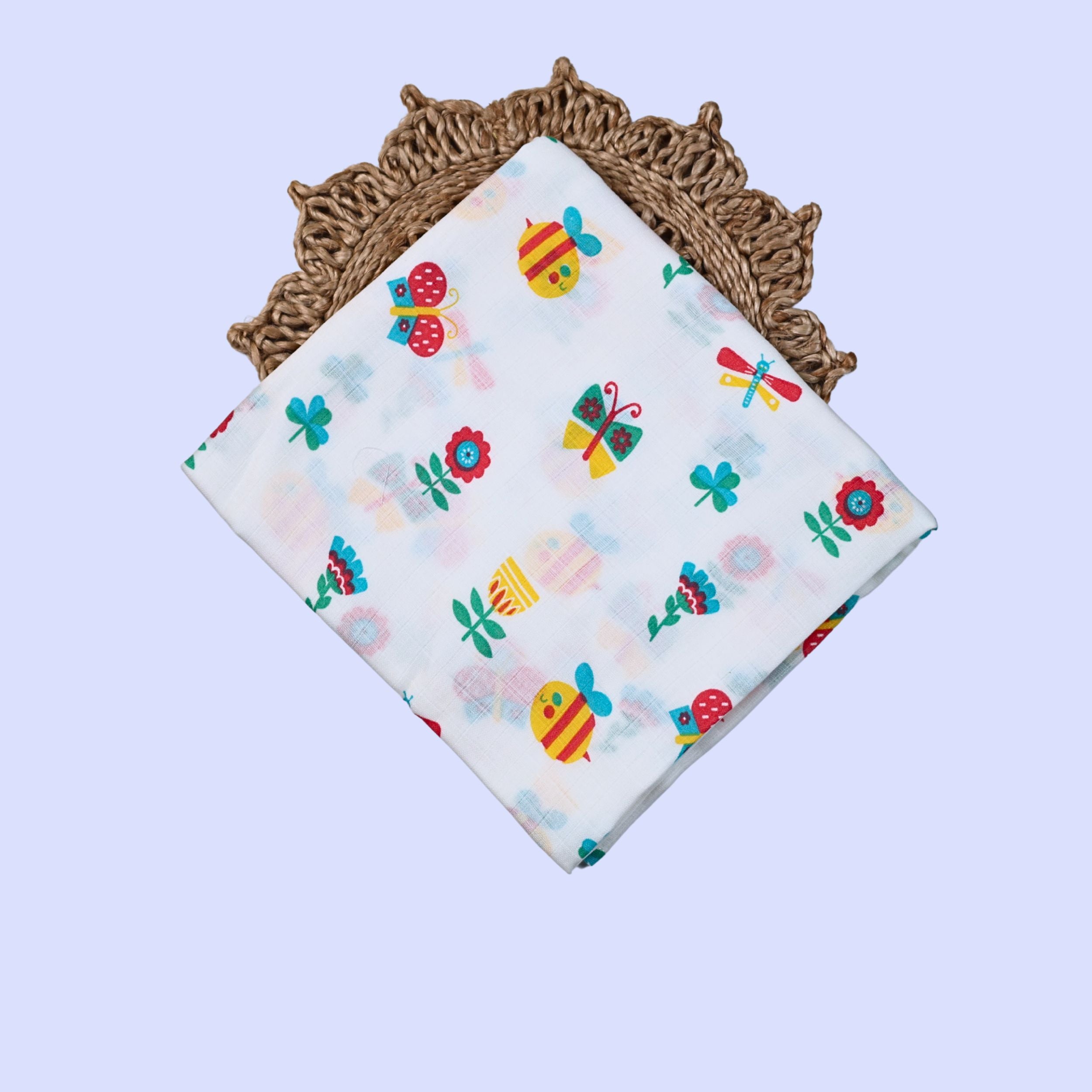 Garden Flutters Baby Swaddle in white printed with colourful flowers, butterflies and dragonflies themed pattern