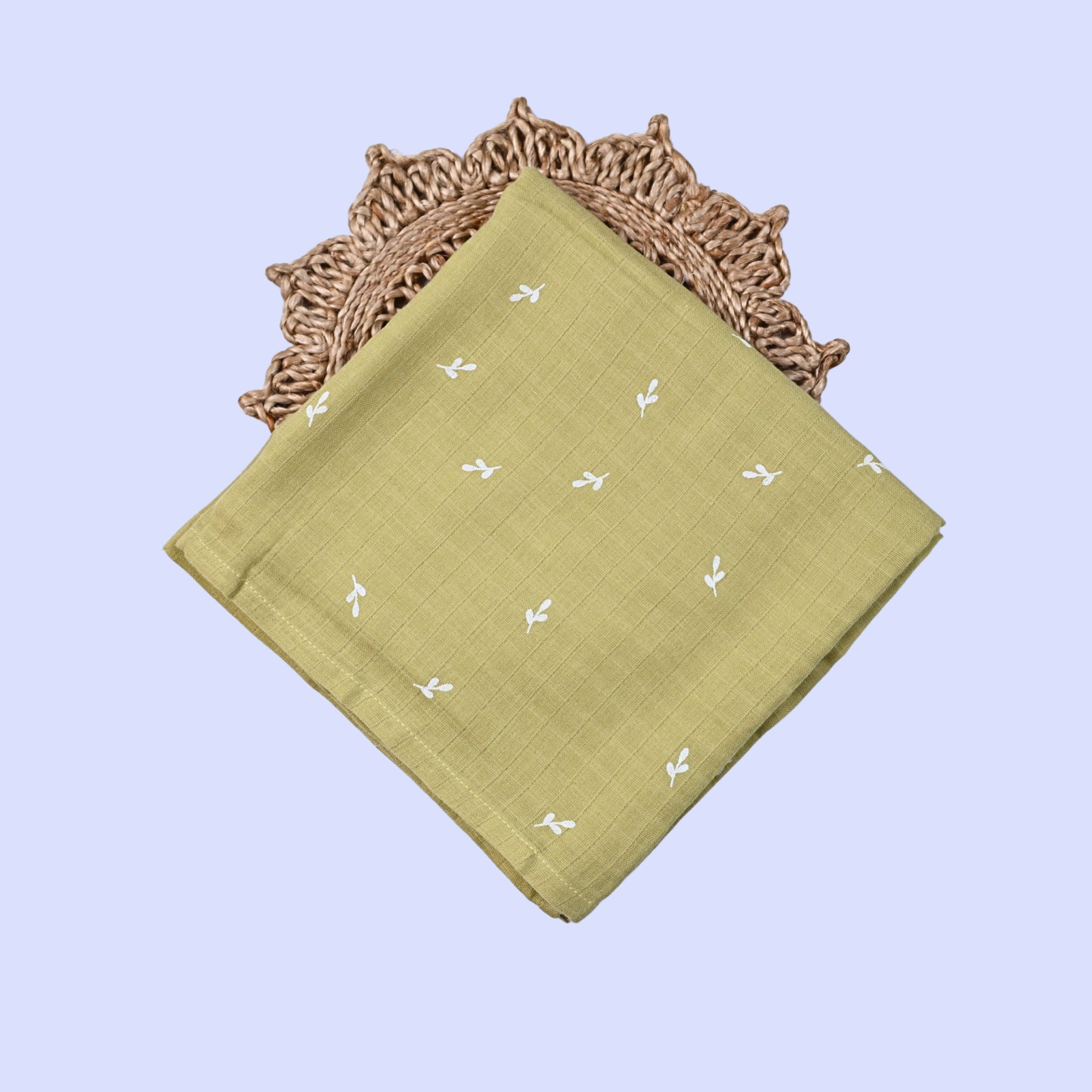 Green Twigs Baby Swaddle in Green fabric with white patterns