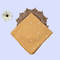 Mustard sprigs Baby Swaddle in Mustard yellow fabric printed with white floral patterns