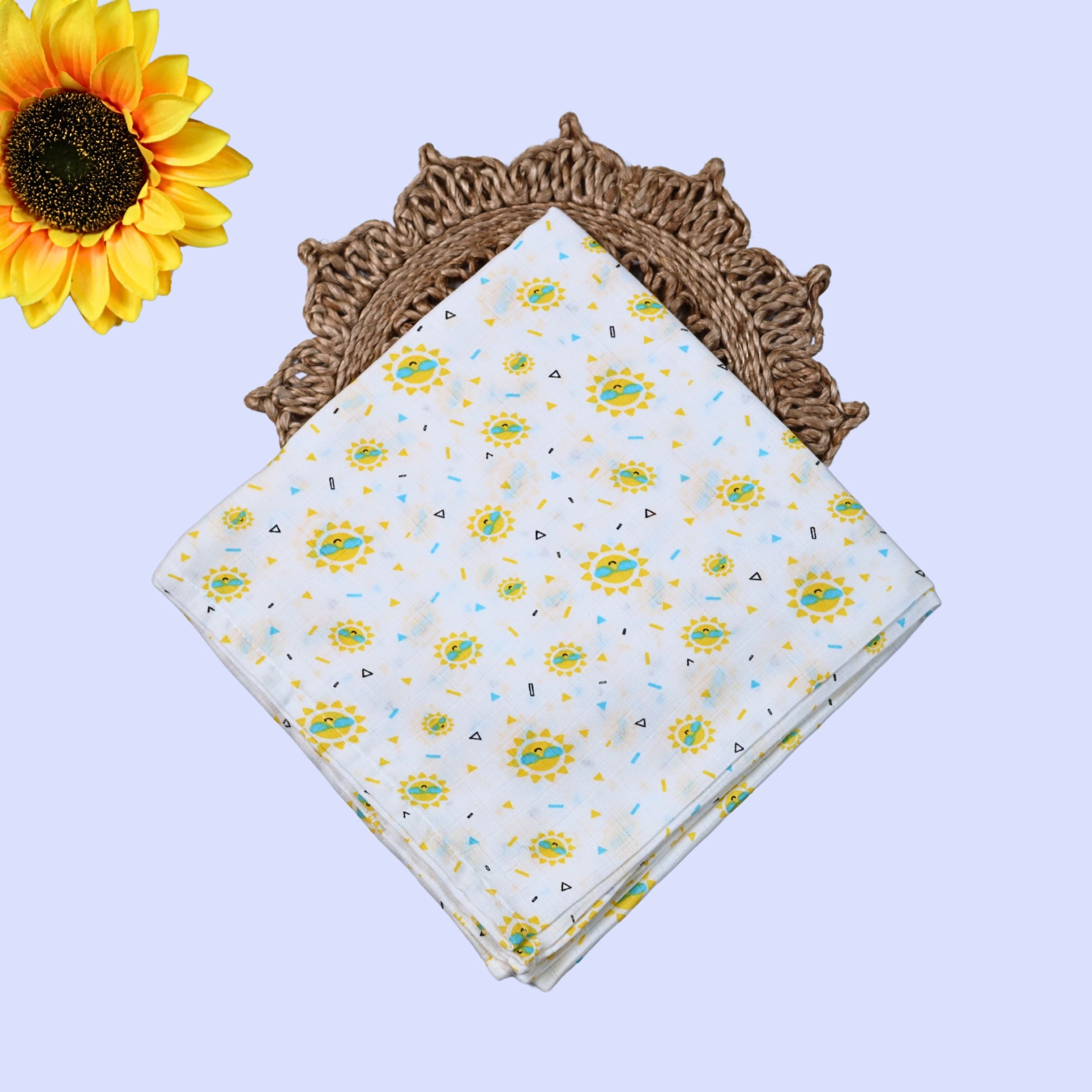 Sunny Smiles Baby Swaddle in white printed with sunflower or sun themed pattern