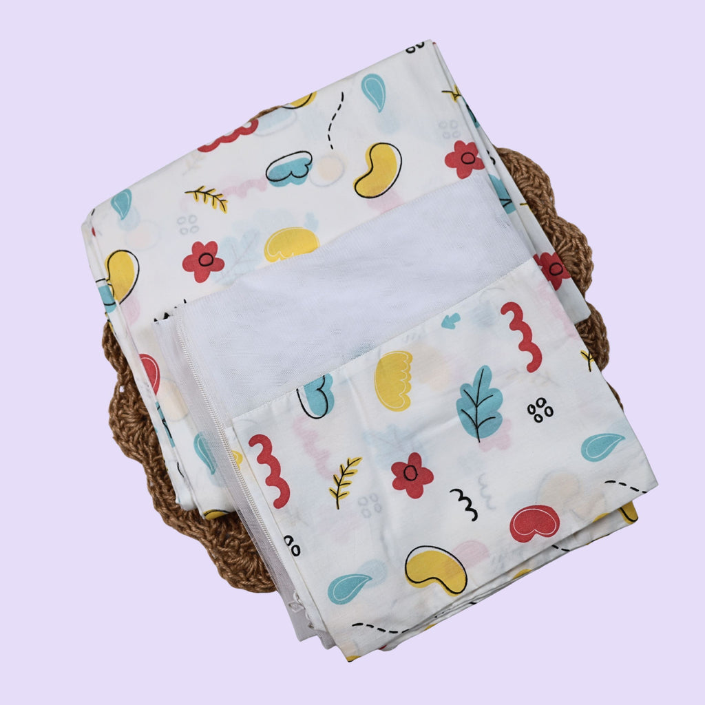 Wild Doodles Baby Thottil (Jhula) in white with mosquito net, printed with yellow, red and pastel green scribble patterns.