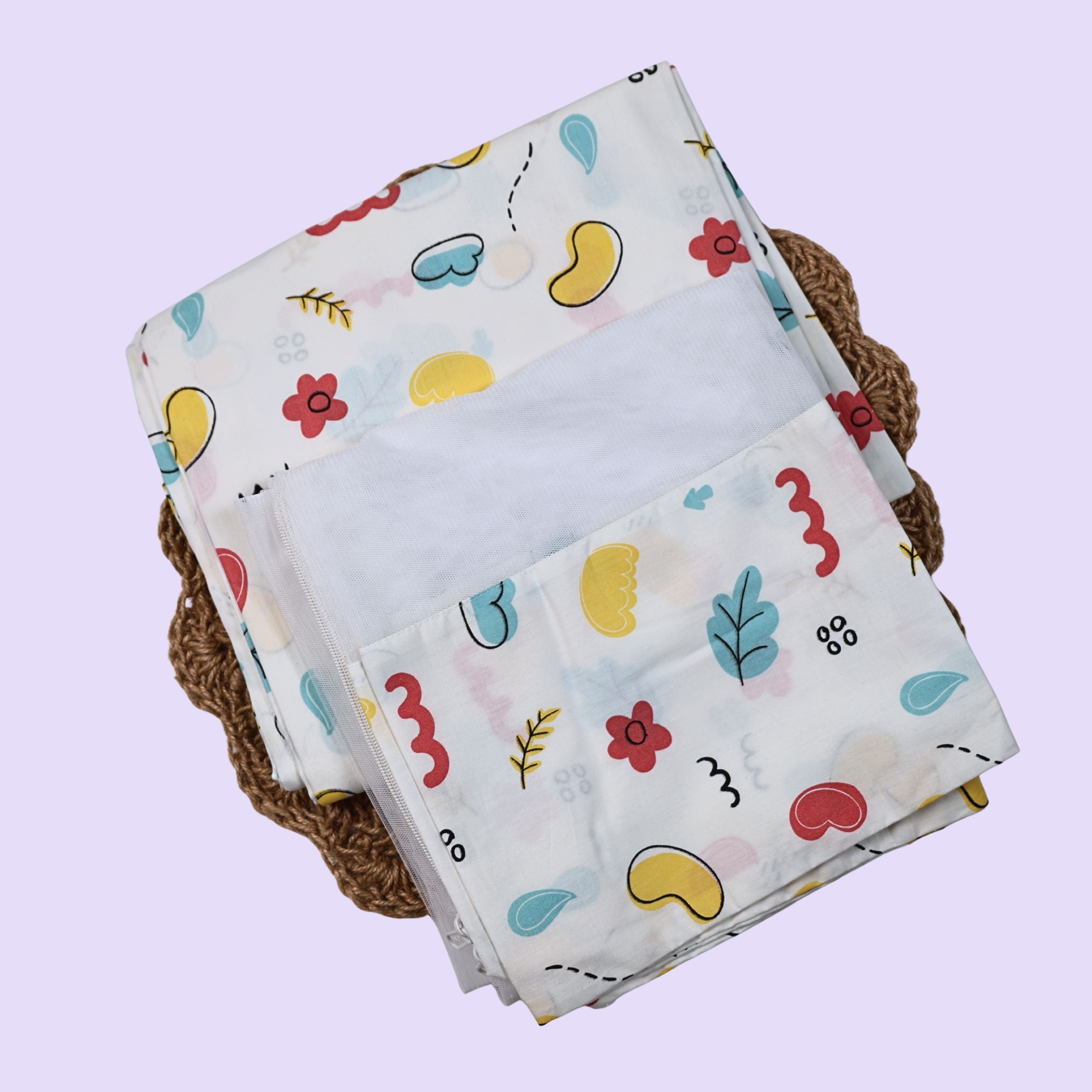 Wild Doodles Baby Thottil (Jhula) in white with mosquito net, printed with yellow, red and pastel green scribble patterns.